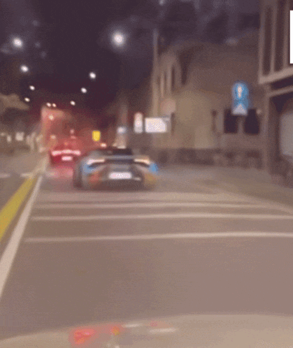 a blurred image of a car driving down a city street