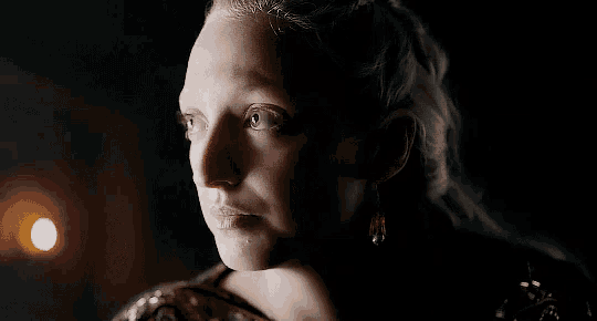 a close up of a woman 's face in the dark