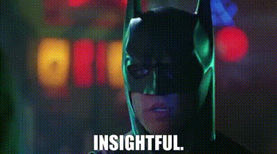 a close up of a person wearing a batman mask with the words `` insightful '' written on the bottom .