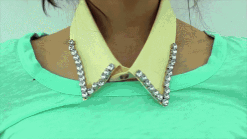 a woman is wearing a red collar with beads on it