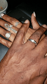a man and woman 's hands with rings on them