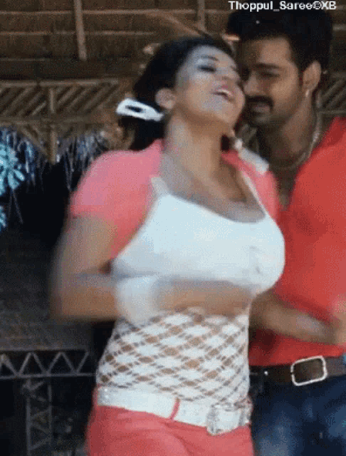 a man and a woman are dancing together and the woman 's breasts are shown