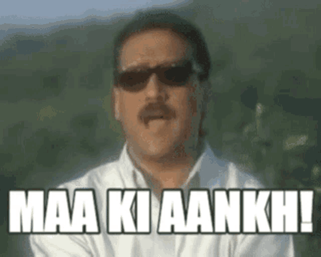 a man wearing sunglasses and a white shirt is saying maa ki aankhe