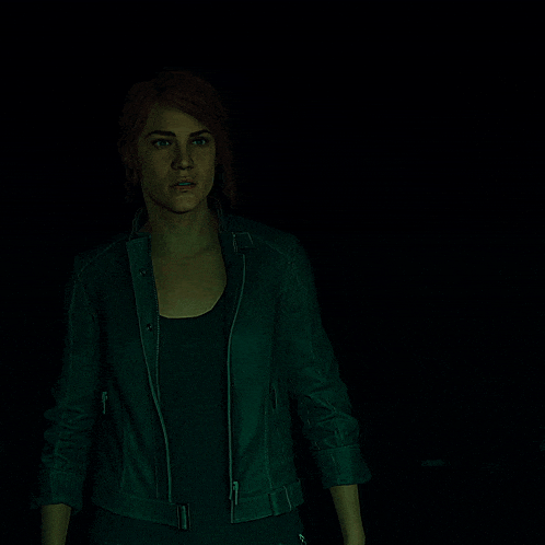 a woman in a green leather jacket is standing in the dark