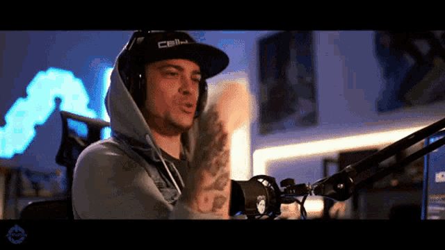 a man wearing headphones and a hat that says cbn on it
