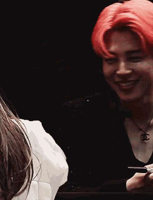 a man with red hair has a chanel necklace on his neck