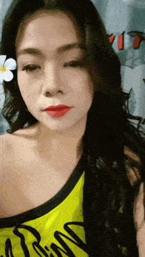 a woman wearing a yellow tank top that says ' rm ' on it