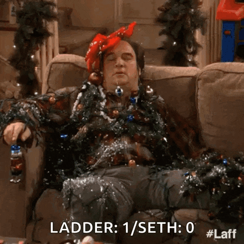 a man is sitting on a couch covered in christmas lights and a ladder .