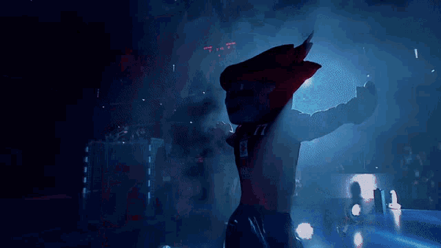 a shark mascot is dancing in the dark