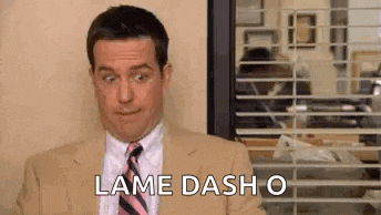 a man in a suit and tie is saying `` lame dash o '' in front of a window .