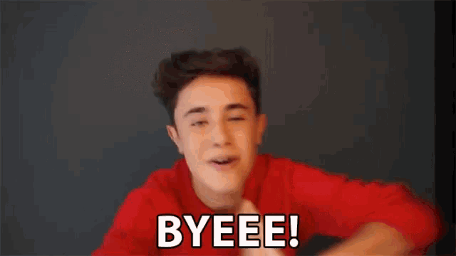 a young man in a red shirt is making a funny face and saying byeee .