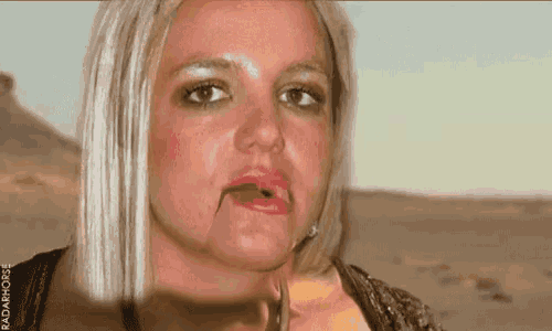 a woman with blonde hair and red lipstick is making a funny face with her mouth open .