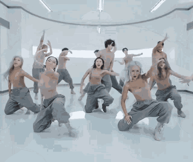 a group of naked dancers are dancing in a room