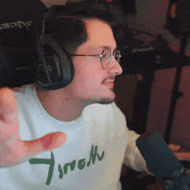 a man wearing headphones and a white shirt that says 7sremm