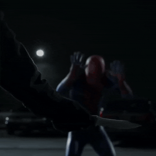 a man in a spiderman costume is kneeling down