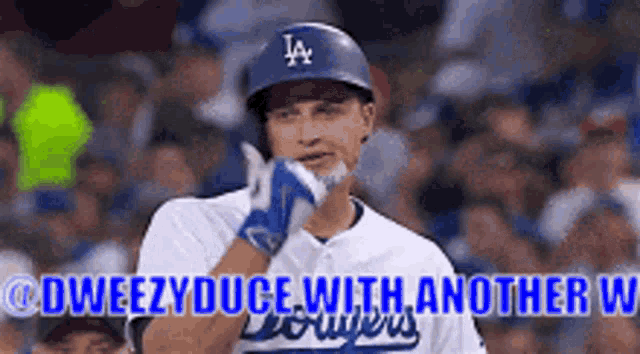a baseball player wearing a helmet and gloves is clapping .