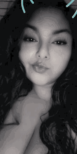 a black and white photo of a woman with a cat ear filter on her face
