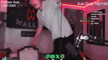 a man stands in front of a microphone with the words follower goal on the top