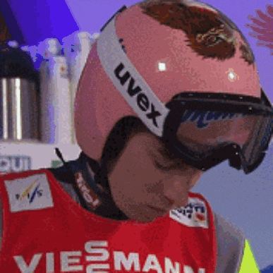 a man wearing a helmet with uvex on it