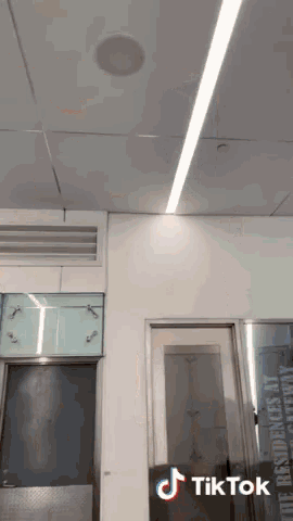 a room with a door and a ceiling that says tik tok