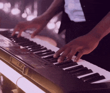 a close up of a person playing a keyboard with a sticker that says casio