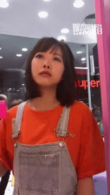 a woman taking a picture of herself in front of a mirror with the word super on it