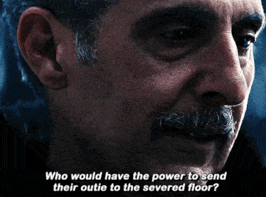 a close up of a man 's face with the words who would have the power to send their outie to the severed floor below him