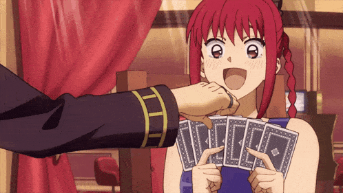 a girl with red hair is holding a bunch of cards in her hands