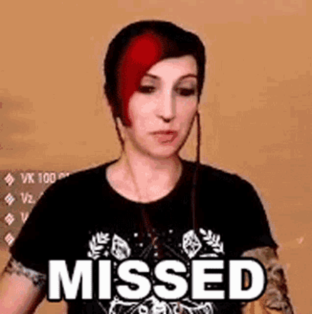 a woman with red hair and headphones is wearing a black shirt that says missed .