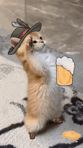 a cat wearing a feathered hat is standing next to a cup of beer