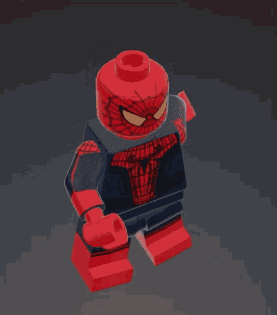 a 3d model of a lego spiderman with a red head and yellow eyes