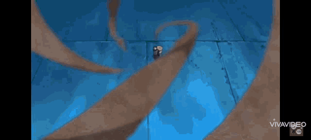 a cartoon character is carrying a bag of sand on his back while standing on a blue surface .