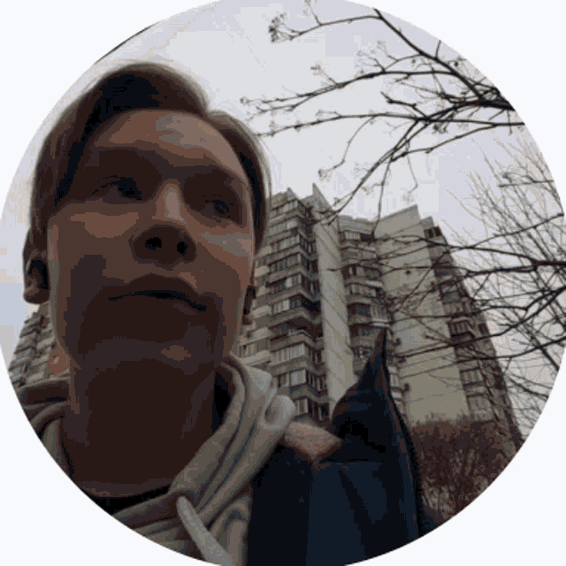 a man standing in front of a tall building