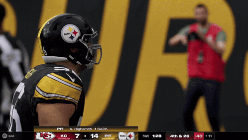 a football player in a pittsburgh steelers uniform looks to his left