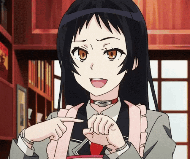 a girl in a suit and tie is pointing at something