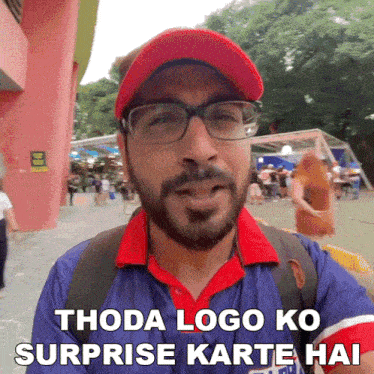 a man wearing glasses and a red hat with the words thoda logo ko surprise karte hai