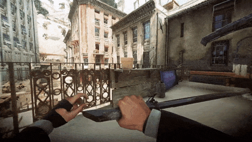 a person holding a sword in front of a balcony