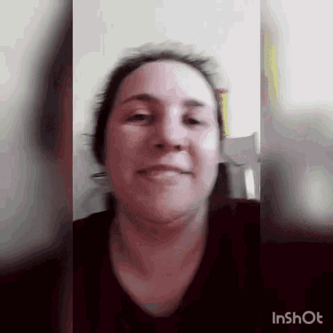 a woman is making a funny face in a blurry photo .
