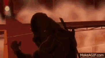 a man in a video game is standing in front of a red light .