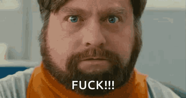 a man with a beard and blue eyes is making a funny face and saying `` fuck '' .