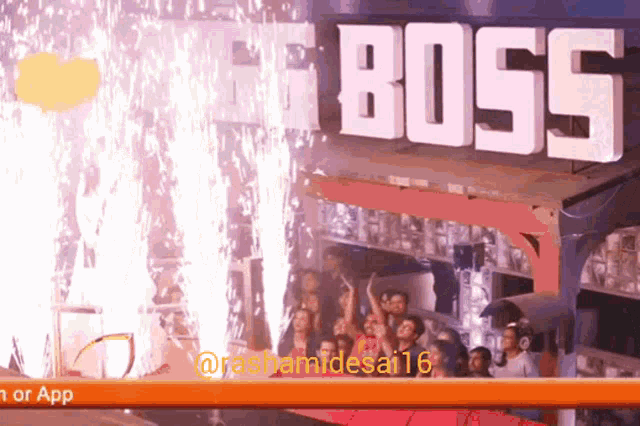 a group of people are standing in front of a big boss sign