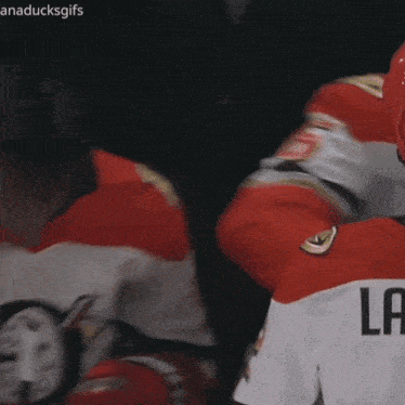a hockey player wearing a bauer helmet looks surprised