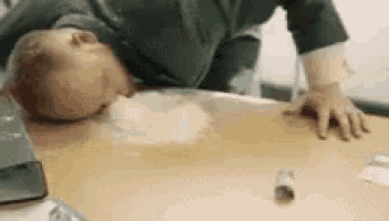 a person is laying on their back on a table with a cigarette in the foreground .