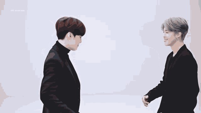 two men are standing next to each other and one of them is wearing a black shirt