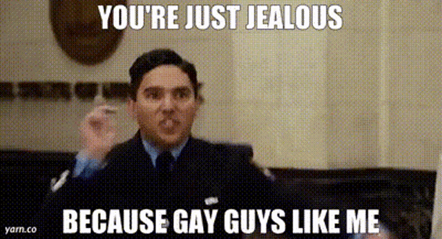a man in a suit and tie is giving a speech and says you 're just jealous because gay guys like me