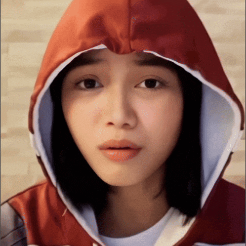 a woman wearing a red and white hooded jacket
