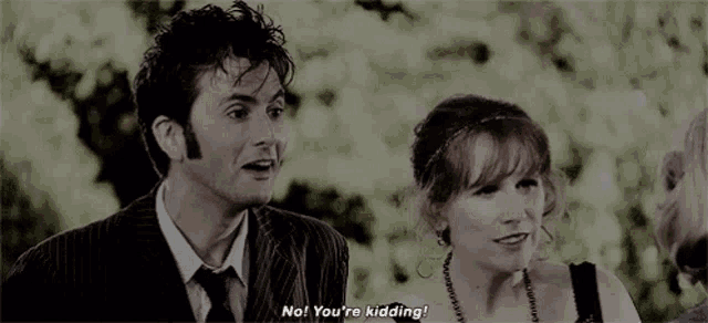 a man and a woman are standing next to each other and the man is saying `` no , you 're kidding ! ''
