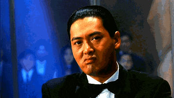 a man in a tuxedo and bow tie looks serious