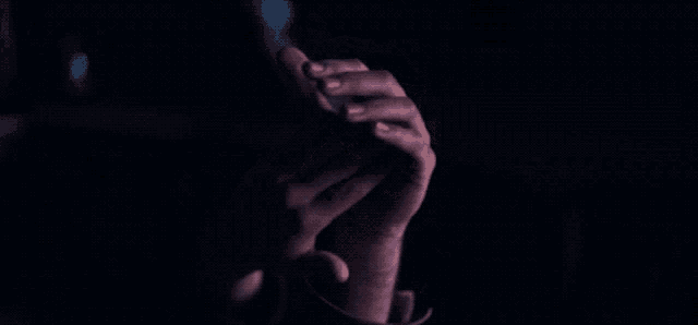 a man and woman laying in a dark room