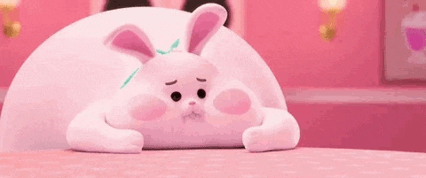 a pink bunny is eating a stack of pancakes .